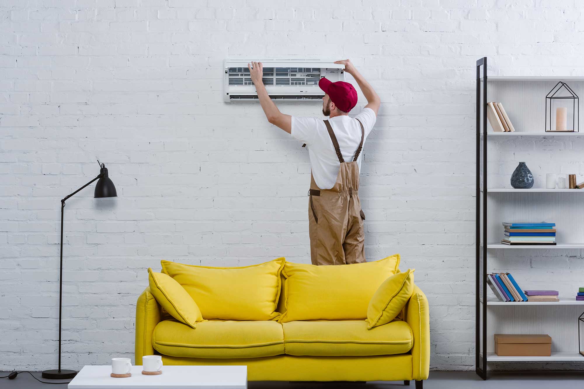 young-professional-repairman-fixing-air-conditione-2022-12-16-20-44-20-utc