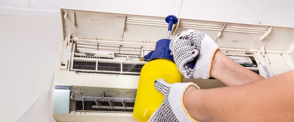 technician-spraying-chemical-water-onto-air-condit-2021-09-01-22-05-03-utc